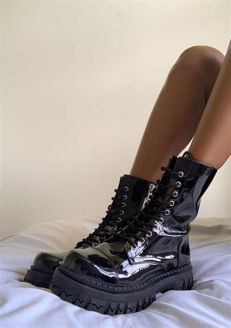 Leather platform combat boots in black .